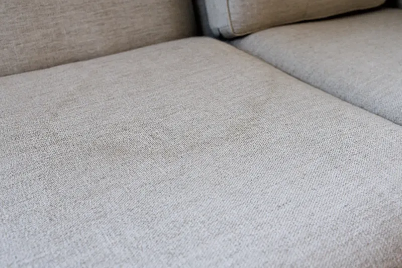 Much-used sofa seat looking spotted and dull