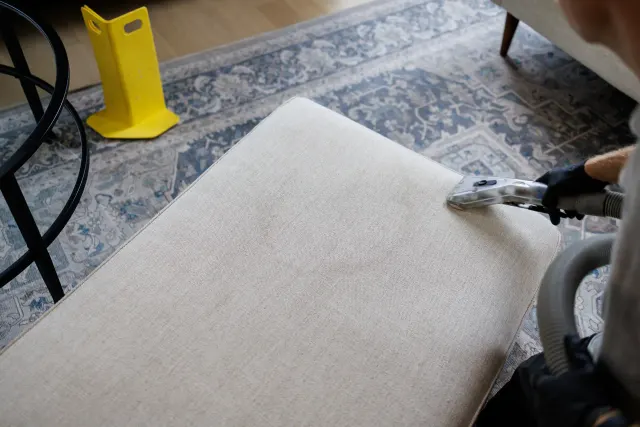 Technician extracting a cushion in a home, with furniture on protective blocks